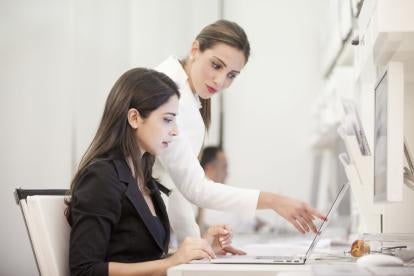 Women Working Together on Computer