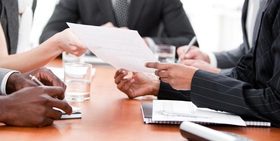 corporate leaders discussing a lawsuit plea