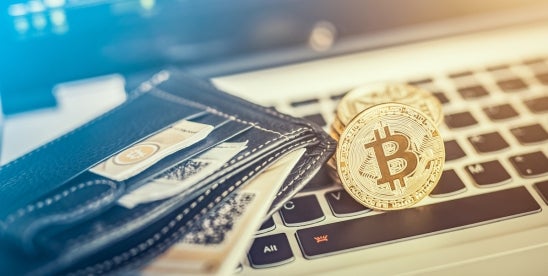 cryptocurrency on a keyboard with a wallet