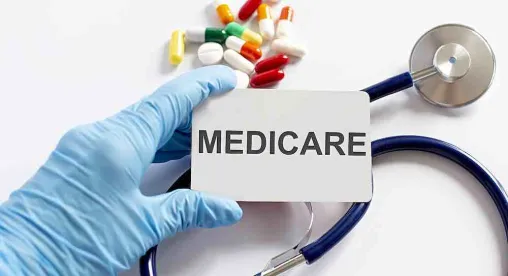 Medicare on a card held by hand with blue glove