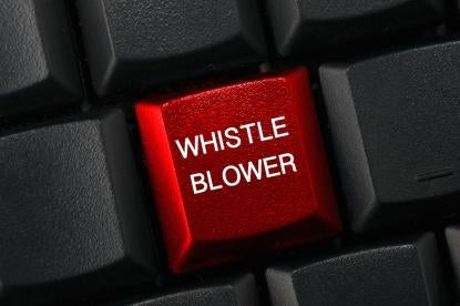 whistleblower key on the whistleblower keyboard in a white-collar criminal's office
