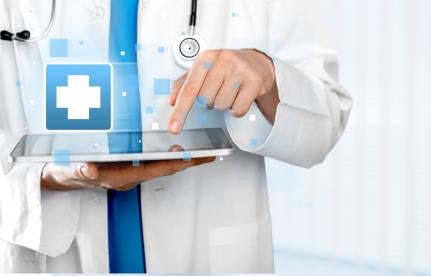 doctor accessing medical information from a tablet or ipad like device