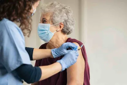 Elderly woman getting a vaccine