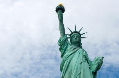 lady liberty holds up the light for you to fill out your immigration paperwork