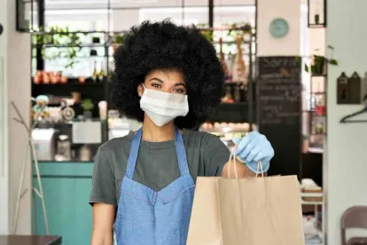 Take out worker complying with COVID requirements