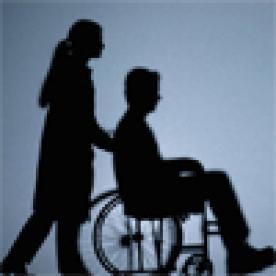 person pushing man in wheelchair
