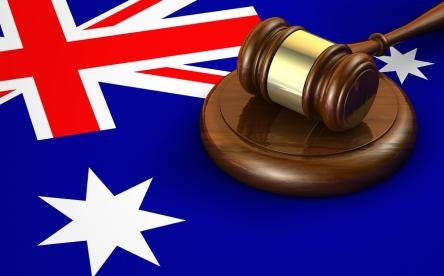 australian gavel and flag where whistleblower regulations are enforced