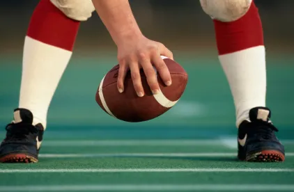 hand on football
