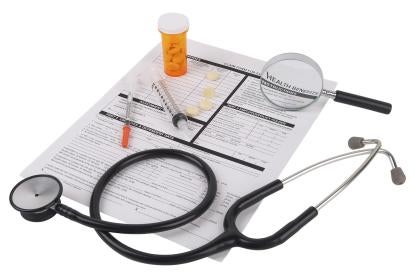health insurance forms with pills stethoscope