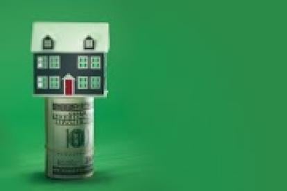 single family house on a roll of cash, mortgage