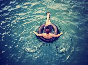 man on a tube in water, pennsylvania triathlete