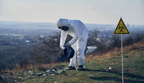 examining trash toxic hazmat suit 