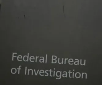 Federal Bureau of Investigation FBI on grey sign