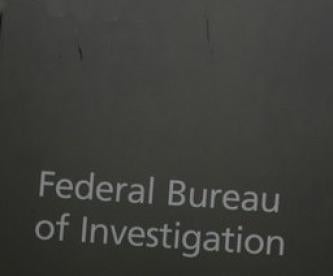 Federal Bureau of Investigation FBI on grey sign