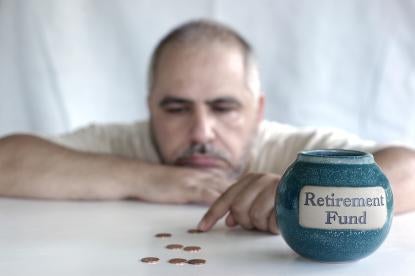 sad man counting pennies by a pottery style jar with text Retirement Fund