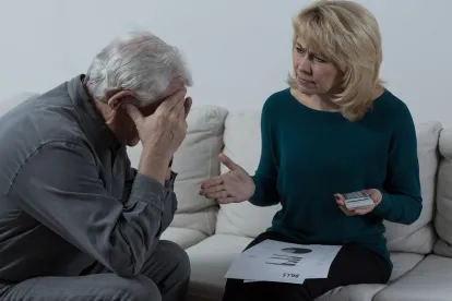 stressed looking senior couple discussing their 2020 cost of living adjustments