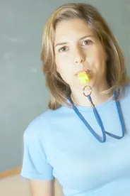 Woman blowing whistle